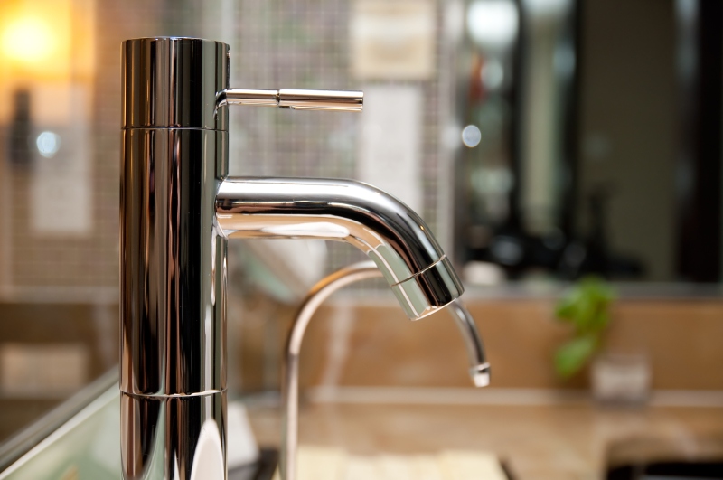 Leaking tap being repaired in Acton